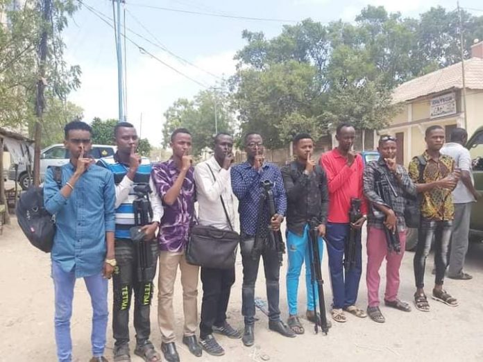 Journalists close their mouths with fingers as a protest in Jowhar town on 8 February, 2021.