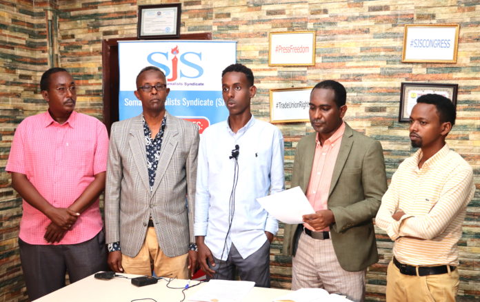 Sharma'arke Abdinur Wehliye (centre) speaks during a press conference today